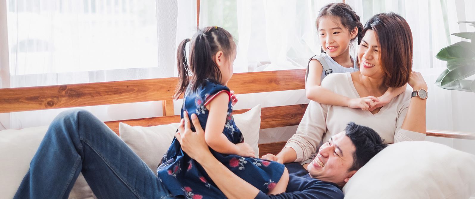 Woman at home in sunglasses and sun hat with child and dog.