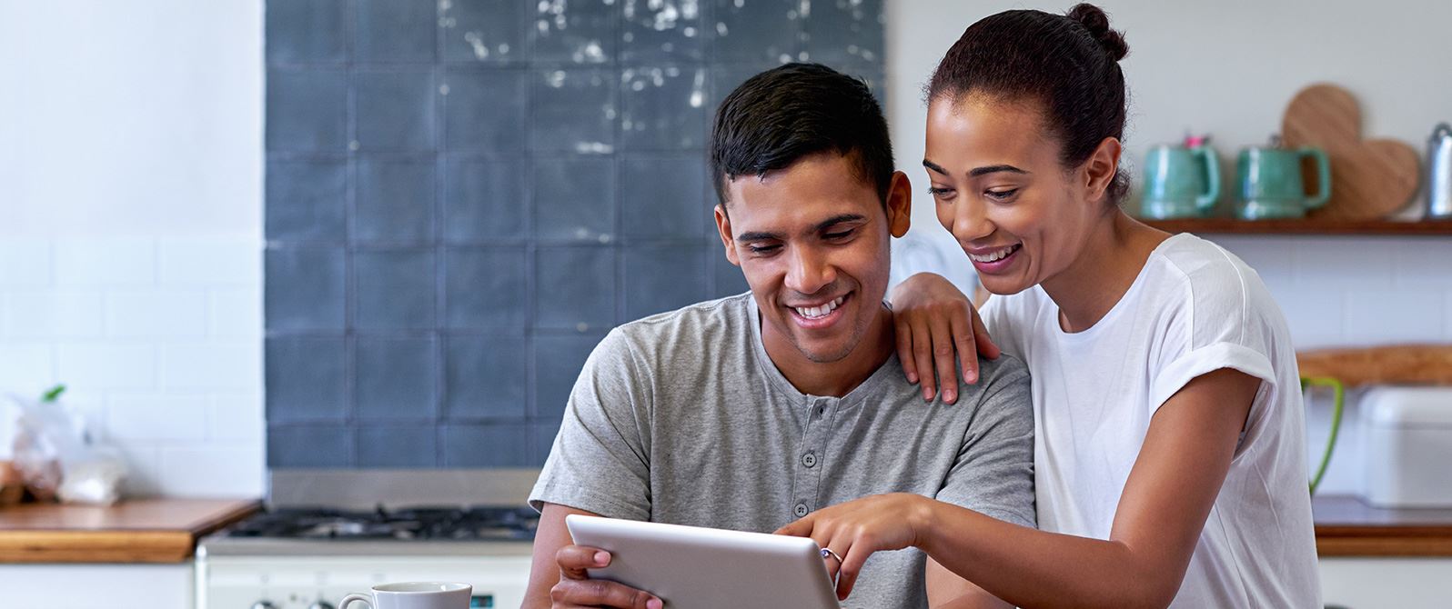 A couple looking at their tablet